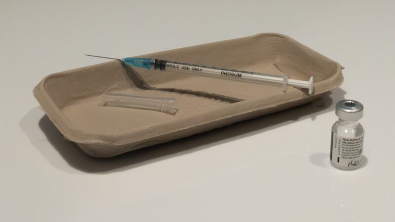 A vaccine vial and syringe