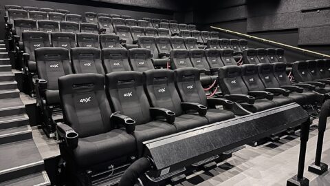 Cinema auditorium seats facing a screen area