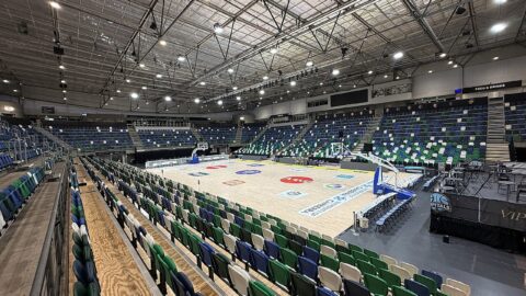 Indoor basketball arena with court and seating