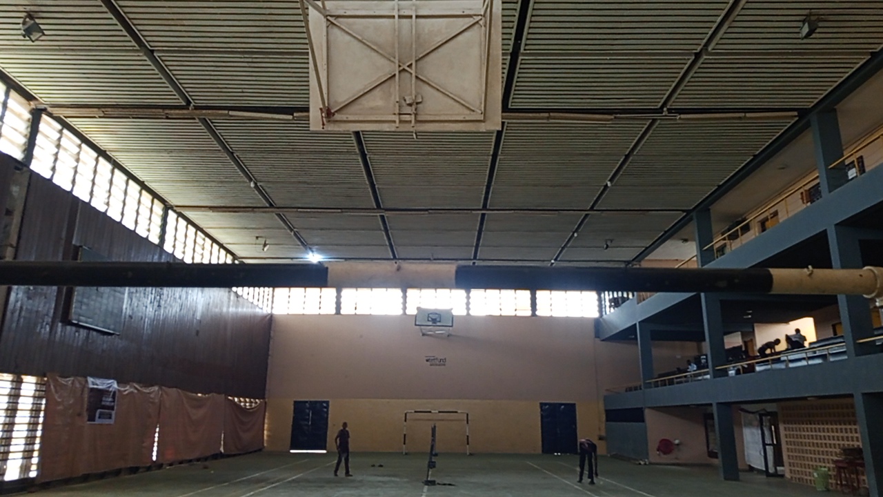 Indoor gymnasium with a wall-mounted basketball hoop