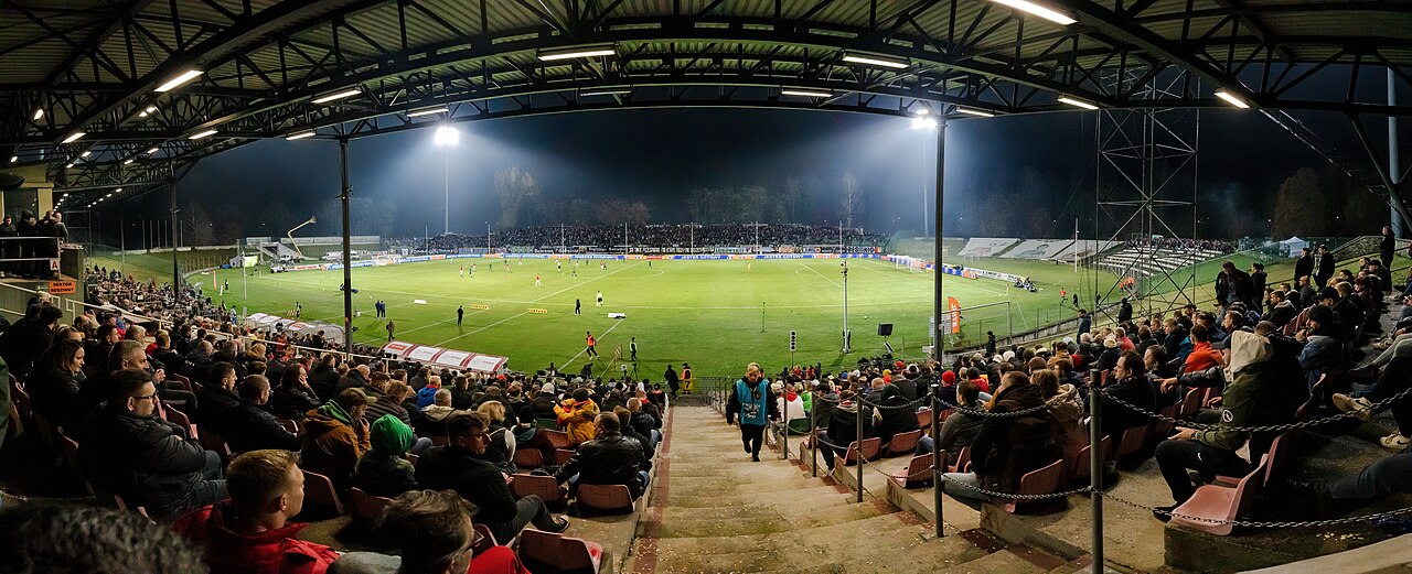 Football stadium crowd and pitch at night