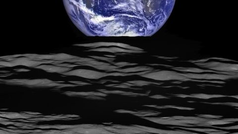 Earth rising over the Moon's cratered surface