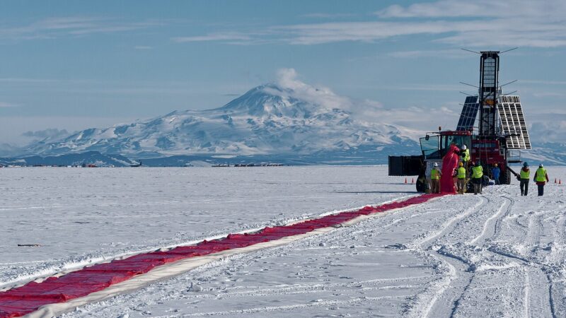 Scientific balloon launch site on snow with mountains