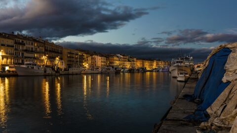 Canal waterfront at dusk with boats and buildings