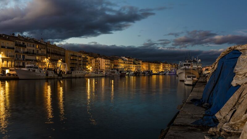 Canal waterfront at dusk with boats and buildings