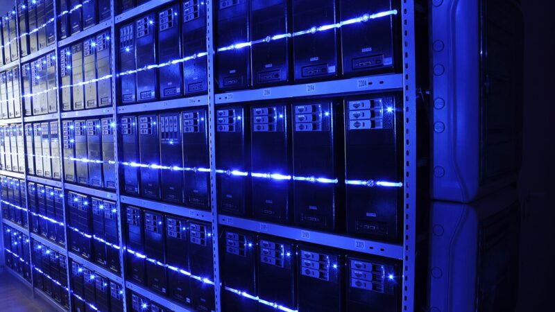 Rows of servers in a data centre with blue lighting