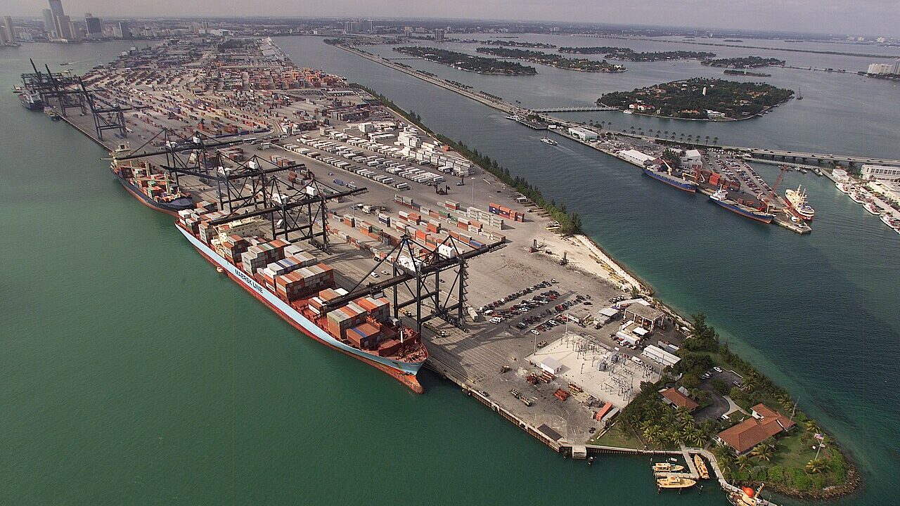 Aerial view of a container port with cargo ships and cranes