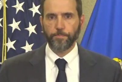 Former special counsel Jack Smith speaking at a podium