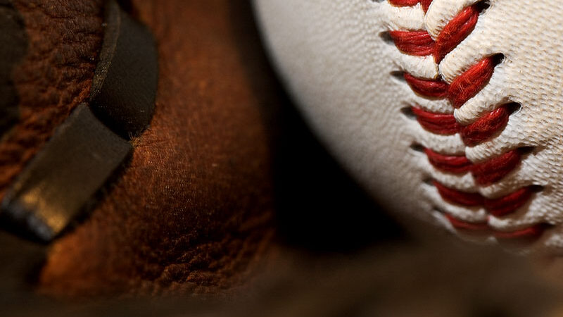 Baseball resting in a leather glove