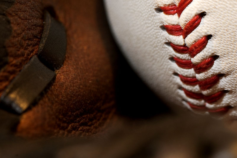 Baseball resting in a leather glove