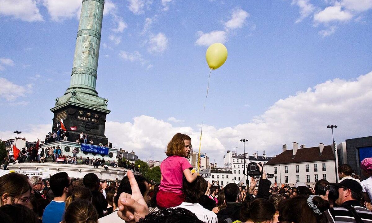 Crowd gathered at a demonstration in Paris in a public square