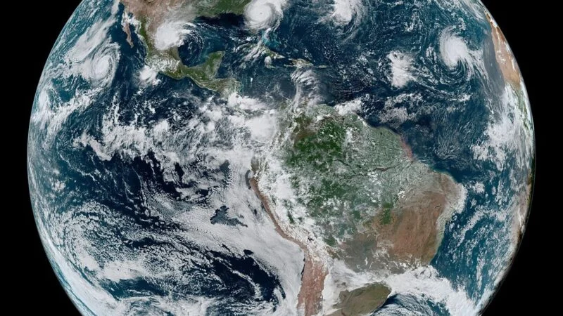 Satellite view of Earth showing storm systems over the oceans